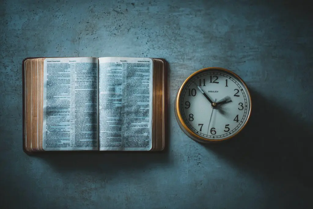 A clock next to a Bible addressing the FAQ on how long should I read the Bible per day A clock next to a Bible addressing the FAQ on how long should I read the Bible per day