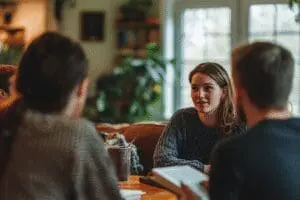 A person leading an engaged small group in a Bible study, fostering a warm and collaborative discussion in a cozy room