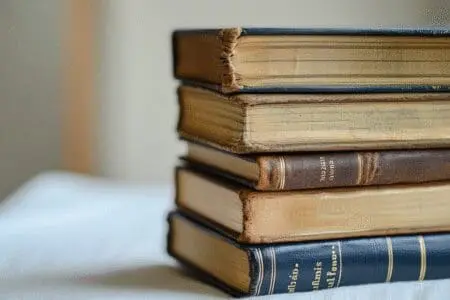 A stack of Bible books with one clearly thicker and highlighted, representing the largest book