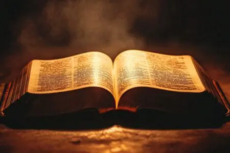 An open Bible perfectly balanced, with a precise light on its middle verse, showing the exact center