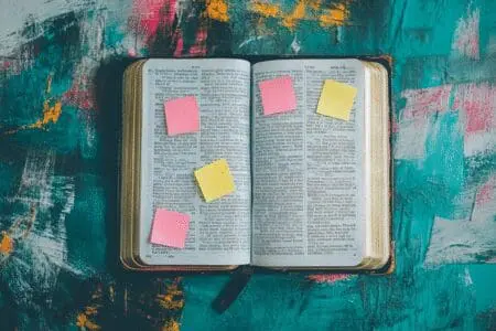 An open Bible seen from above, with small sticky notes marking verses to provide helpful tips for a good place to start