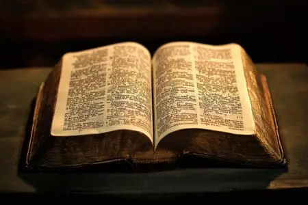 An open Bible with a common word repeated, converging to reveal the most used word