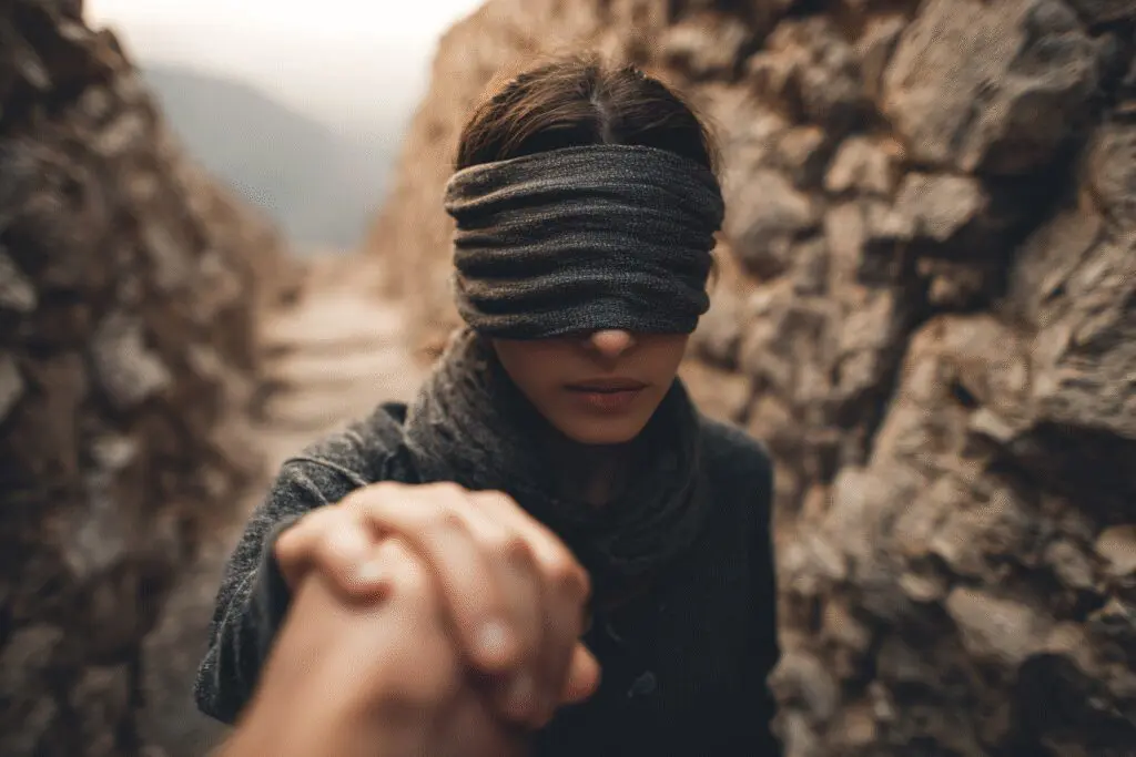 A blindfolded person being guided by anothers hand representing the answer to the FAQ on what is faith in the Bible A blindfolded person being guided by anothers hand representing the answer to the FAQ on what is faith in the Bible
