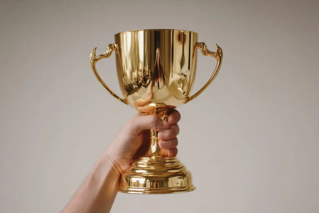 A gold trophy reflecting a Bible representing the FAQ on which Bible version is the best A gold trophy reflecting a Bible representing the FAQ on which Bible version is the best