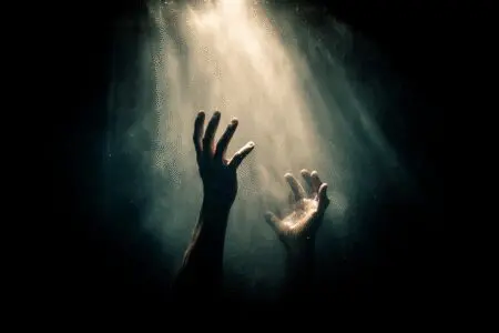 A hand from the light rescuing hands from the dark symbolizing how can I be saved