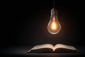 A lightbulb illuminating an open Bible a metaphor for finding which version of the Bible is easiest to understand