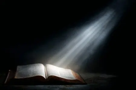 A verse glowing in a Bible answering the question what does the Bible say about reading the Bible