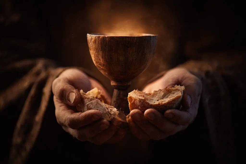 Hands holding a glowing chalice and bread symbolizing what is the New Covenant in the Bible