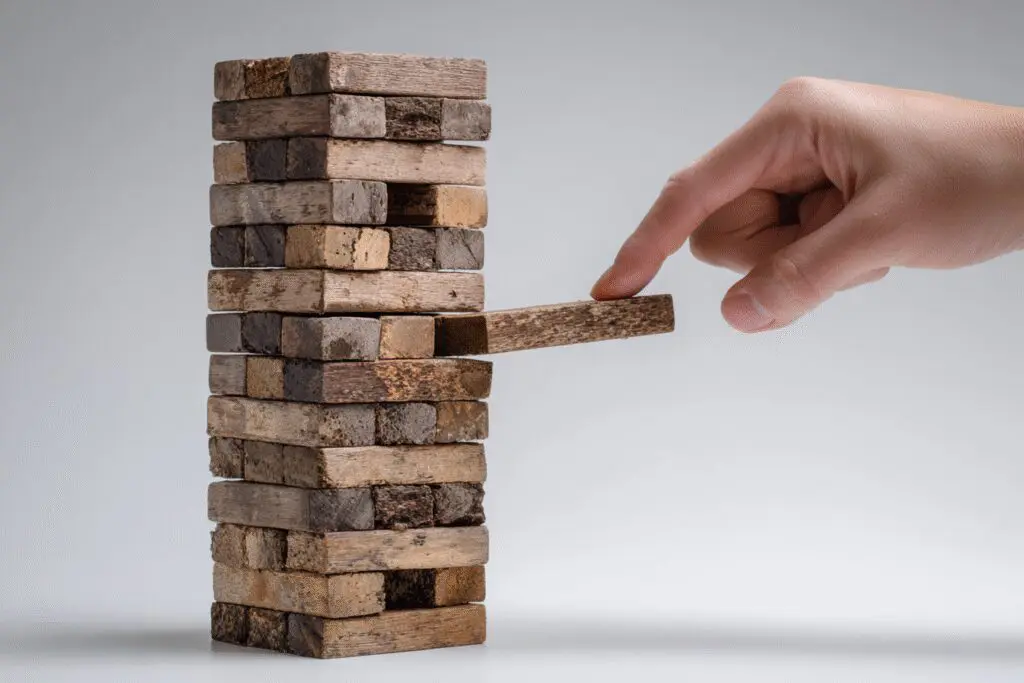 A hand removing a block and making a tower unstable a metaphor for the FAQ on what the Bible says about stealing A hand removing a block and making a tower unstable a metaphor for the FAQ on what the Bible says about stealing