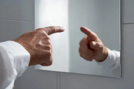 A person pointing a finger that is reflected back at them answering can we judge others according to the Bible