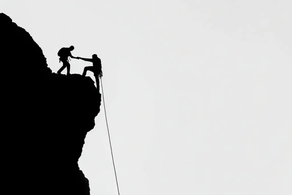 Two climbers roped together helping each other answering the FAQ on a faithful friend Bible verse Two climbers roped together helping each other answering the FAQ on a faithful friend Bible verse