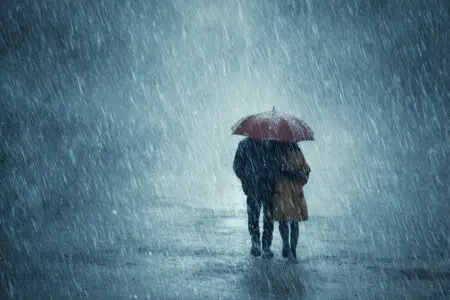 Two people sharing one umbrella in a storm a symbol of a faithful friend