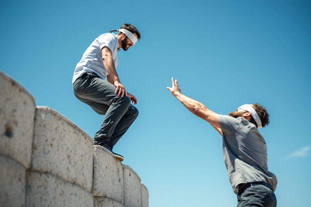 a blindfolded person stepping into the open arms of another a powerful visual metaphor for what the bible says about trusting others